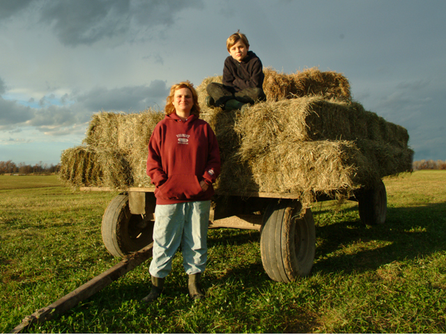 Cheryl deVos and son with hay wagon